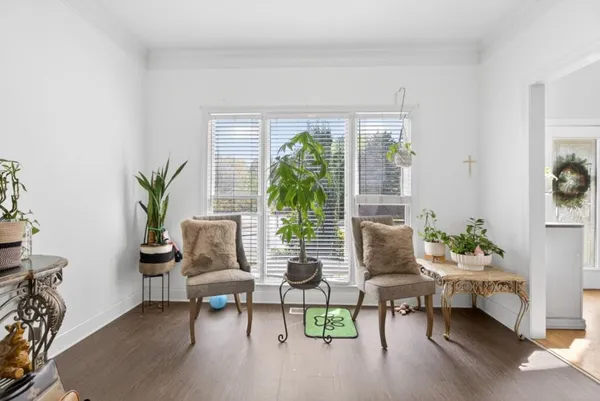 a dining room with furniture a chandelier and wooden floor