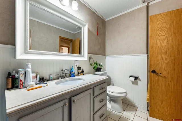 a bathroom with a sink a toilet and shower curtain