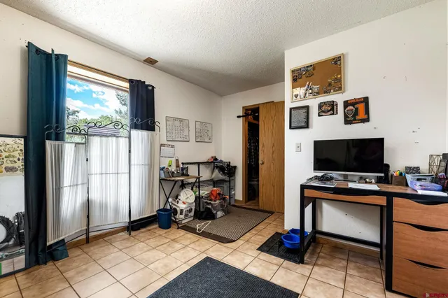 a view of a workspace with furniture and a flat screen tv