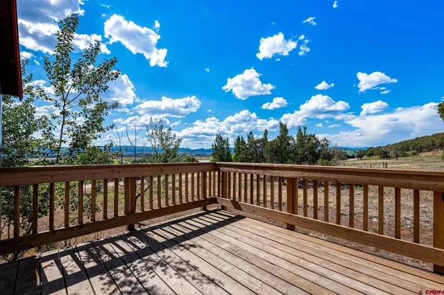 a view of a balcony with wooden floor
