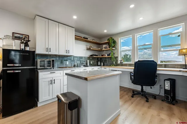 a kitchen with a sink cabinets and wooden floor