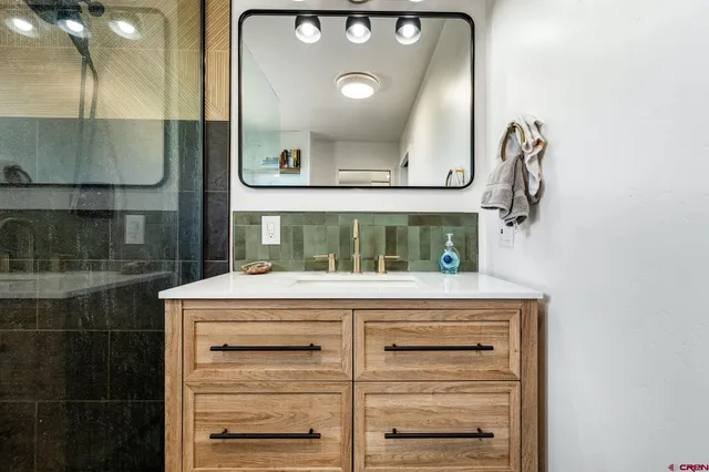 a view of kitchen with a sink and cabinets