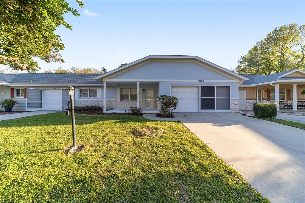 8890 Southwest 96th Street, Unit B Ocala, FL 34481 - Photo 1 of 42 a front view of a house with a yard