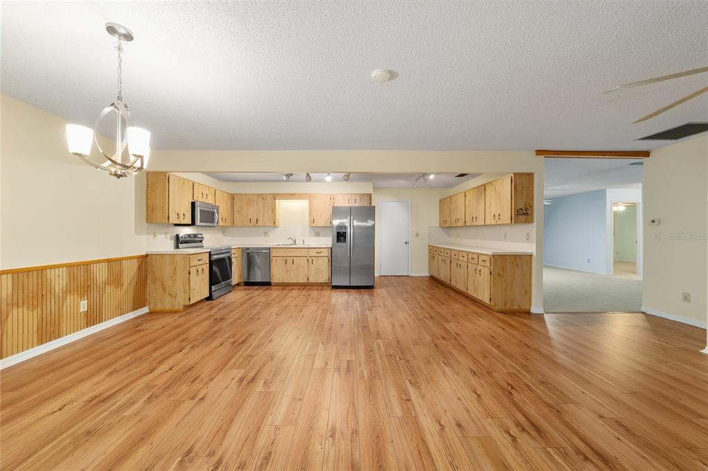 8890 Southwest 96th Street, Unit B Ocala, FL 34481 - Photo 13 of 42 a view of a kitchen with wooden floor and a sink
