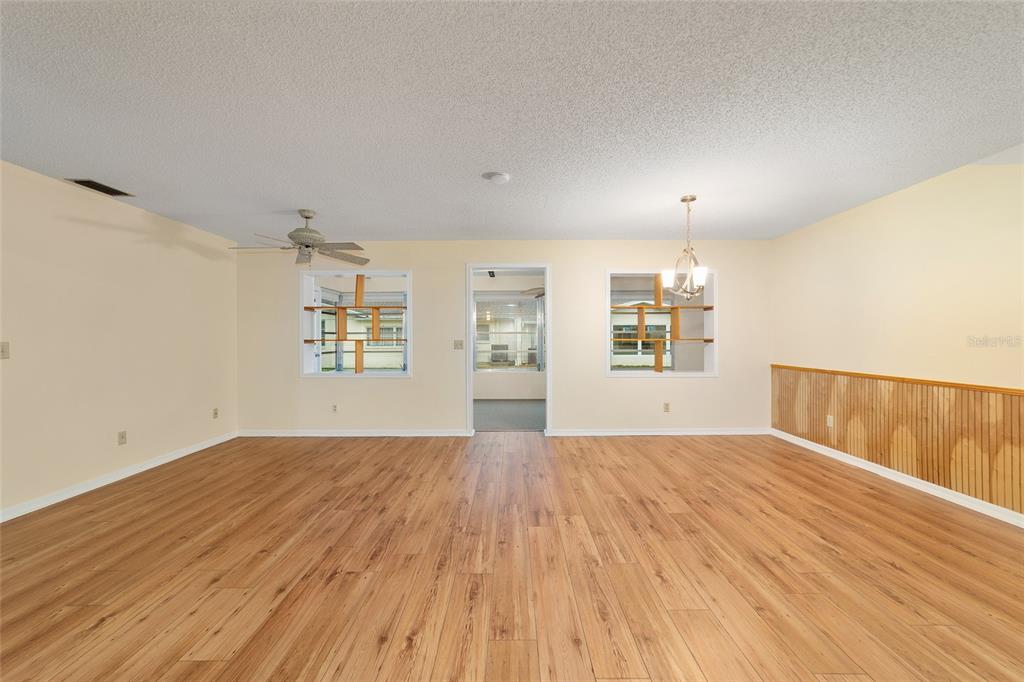 8890 Southwest 96th Street, Unit B Ocala, FL 34481 - Photo 15 of 42 a view of an empty room with window and wooden floor
