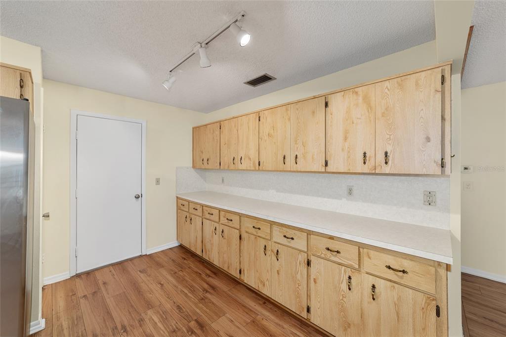 8890 Southwest 96th Street, Unit B Ocala, FL 34481 - Photo 20 of 42 a view of a kitchen with granite countertop cabinets and wooden floor