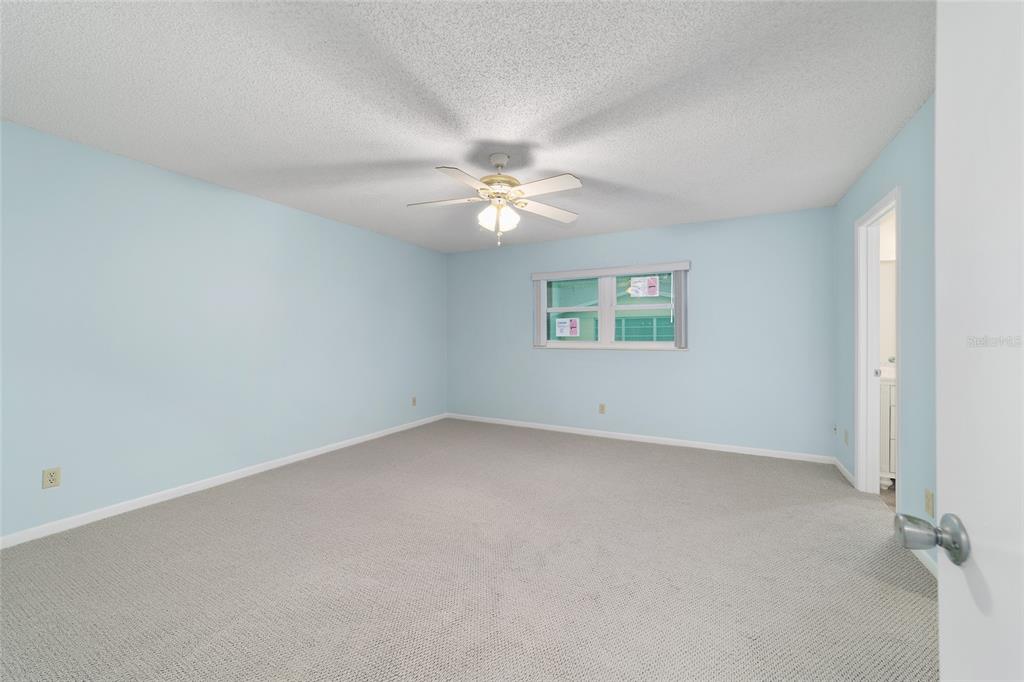 8890 Southwest 96th Street, Unit B Ocala, FL 34481 - Photo 22 of 42 an empty room with a window and a ceiling fan
