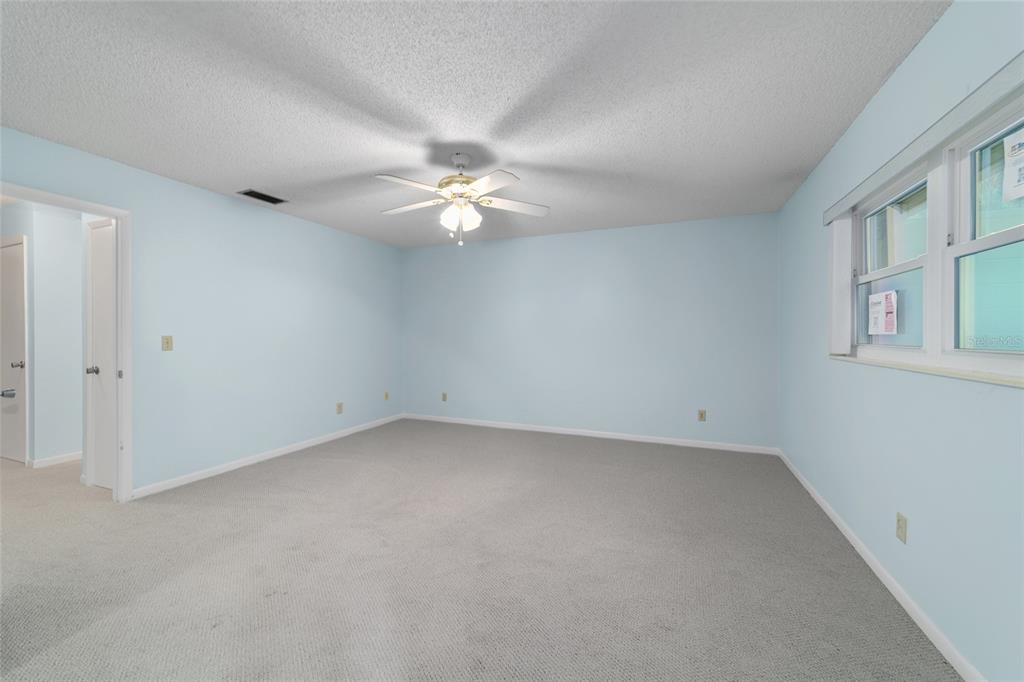 8890 Southwest 96th Street, Unit B Ocala, FL 34481 - Photo 24 of 42 wooden floor in an empty room with a window