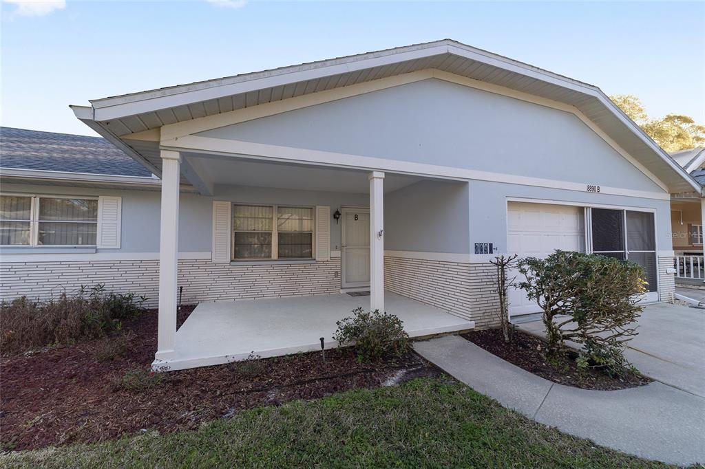 8890 Southwest 96th Street, Unit B Ocala, FL 34481 - Photo 3 of 42 a front view of a house with a yard and outdoor seating