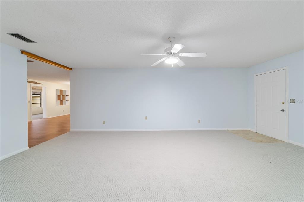 8890 Southwest 96th Street, Unit B Ocala, FL 34481 - Photo 7 of 42 an empty room with fan