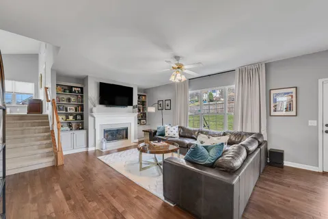 a living room with fireplace furniture and a flat screen tv
