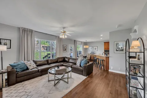 a living room with furniture and a wooden floor