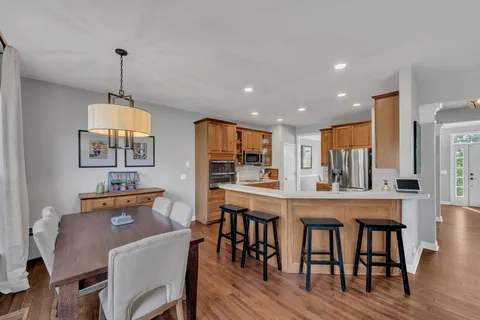 a dining room with furniture window and wooden floor