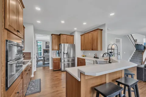 a kitchen with refrigerator and chairs