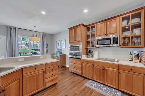 a kitchen with stainless steel appliances sink cabinets and window
