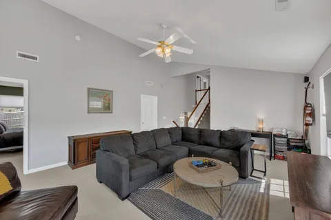 a living room with furniture and a flat screen tv with wooden floor