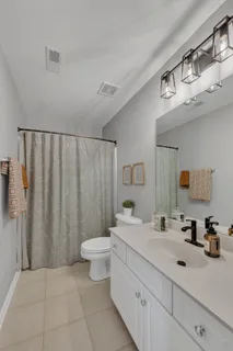 a spacious bathroom with a double vanity sink and a mirror