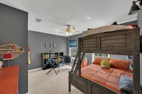 a bedroom with furniture and a chair