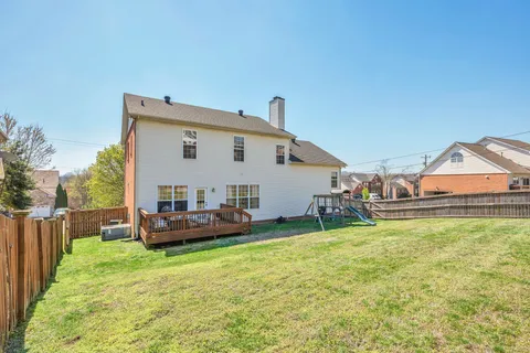 a view of a house with backyard and porch