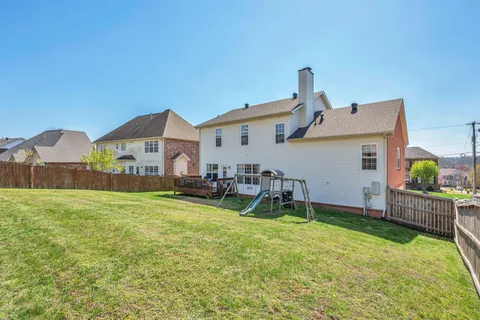 a view of a house with a yard and sitting area