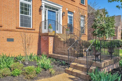 a view of a brick house with plants and a flower plants