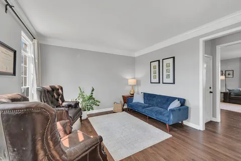 a living room with furniture rug and wooden floor