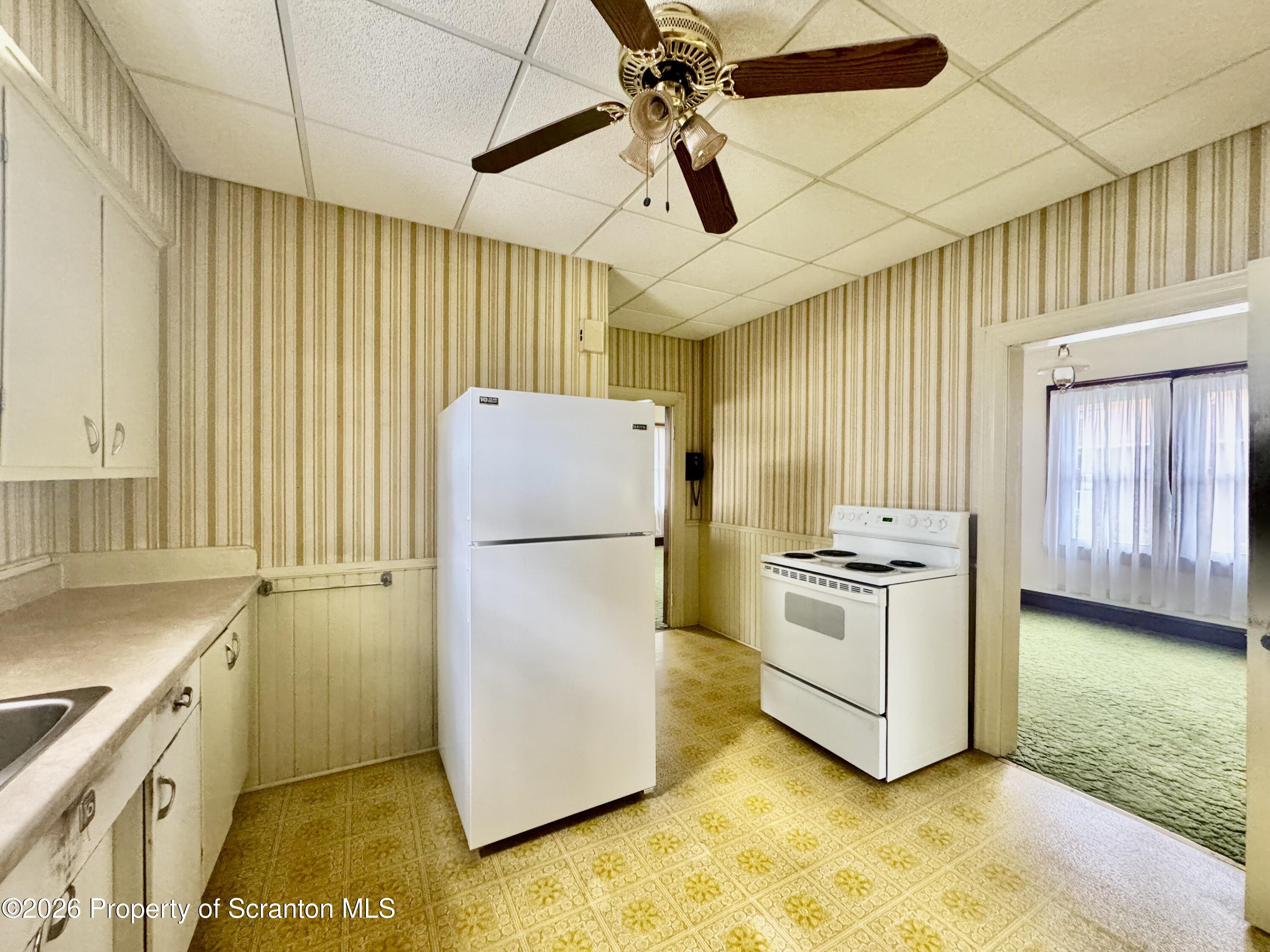 2120 Myrtle Street Scranton, PA 18510 - Photo 21 of 42 a kitchen with a refrigerator a stove top oven a sink and dishwasher