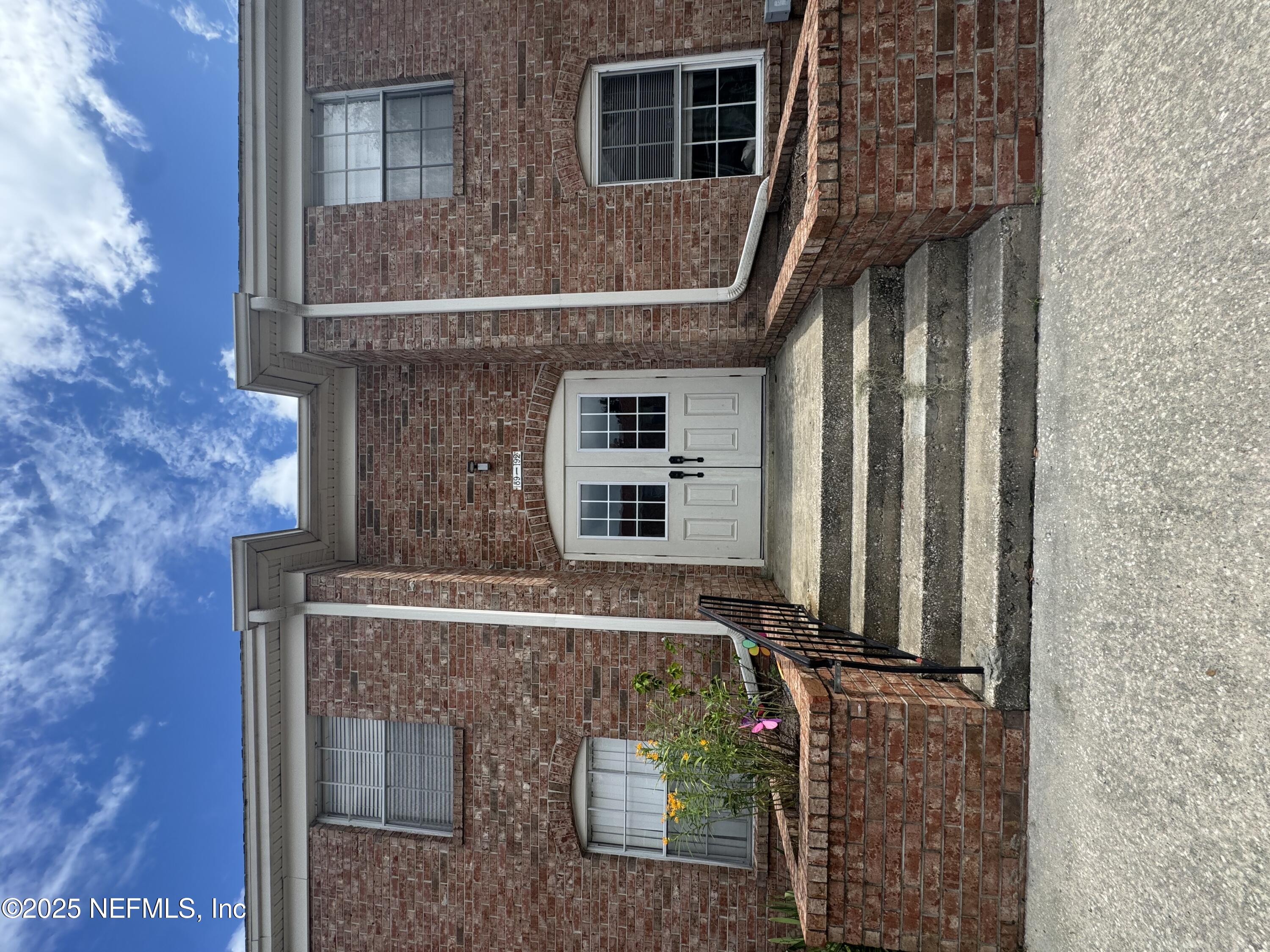 a front view of a house with stairs