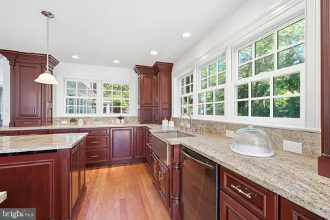 a kitchen with stainless steel appliances granite countertop a sink and stove top oven