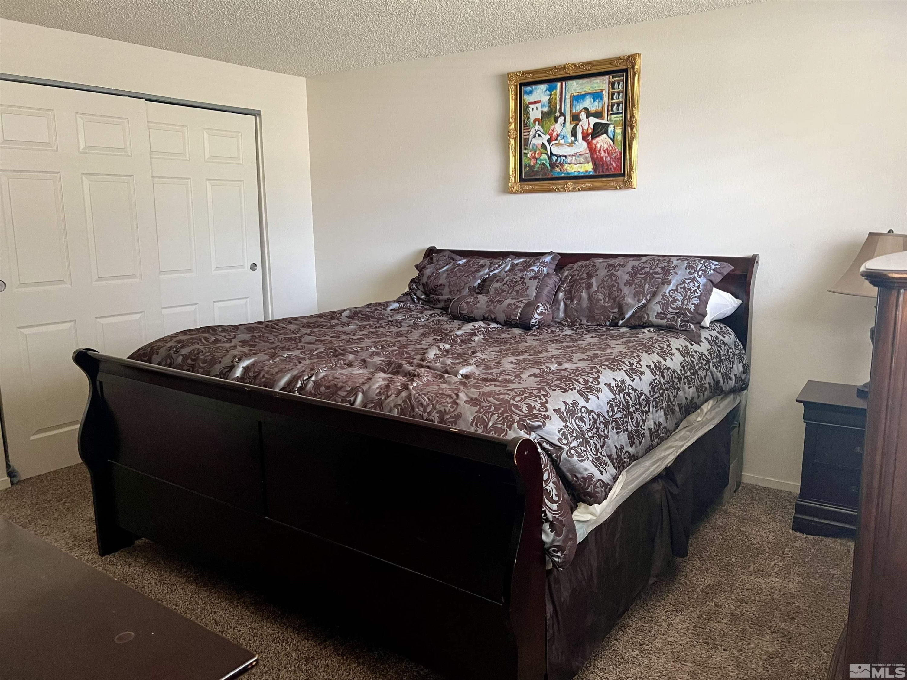 3020 Chavez Drive Reno, NV 89502 - Photo 8 of 15 a bed sitting in a bedroom next to a bathroom