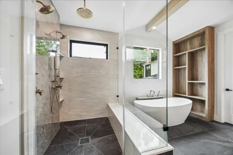 a bathroom with a sink a toilet and shower