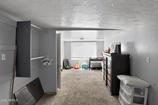 a bed sitting in a bedroom next to a window