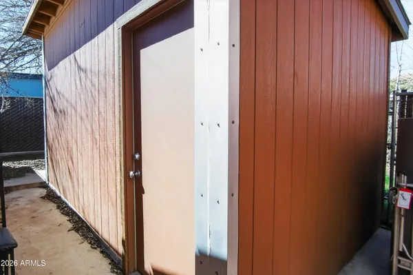 a living room with furniture a air conditioner vent and white walls