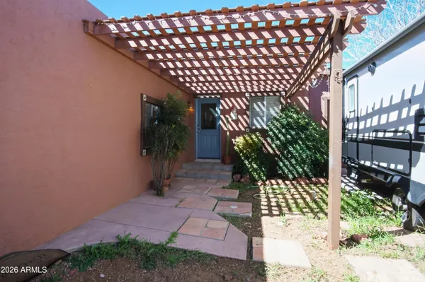 a backyard of a house with table and chairs