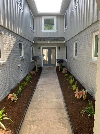 a view of a patio with table and chairs with wooden fence