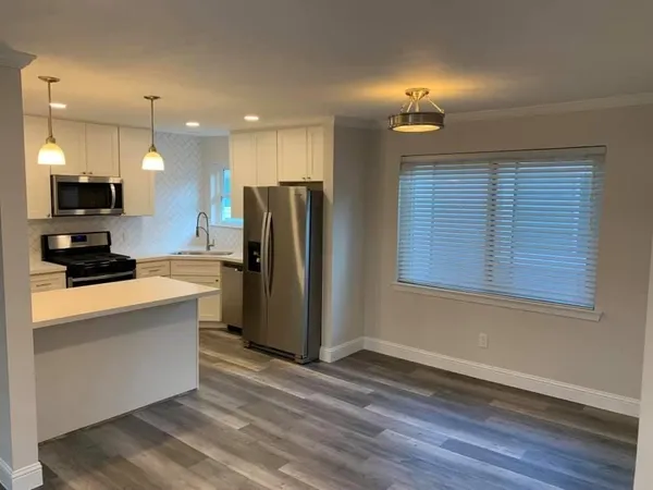 a kitchen with stainless steel appliances granite countertop a refrigerator a stove a sink and a microwave