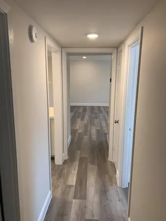 a view of a room with wooden floor