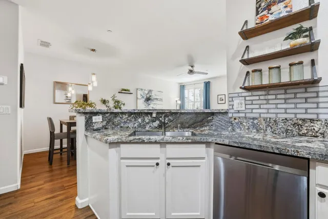 a kitchen with stainless steel appliances granite countertop a refrigerator and a sink