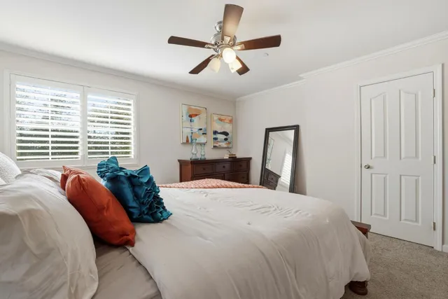 a spacious bedroom with a bed and a window