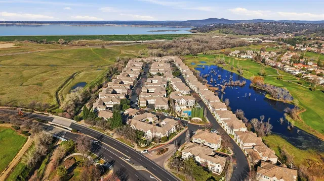 a living room with furniture wooden floor and a dining table