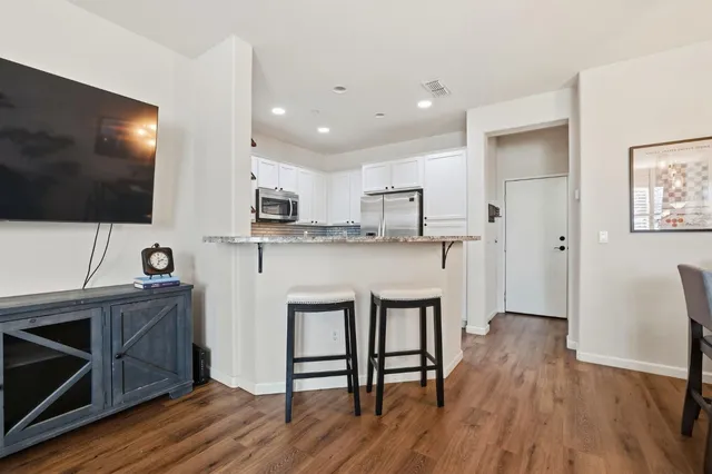 a kitchen with stainless steel appliances a stove microwave and a refrigerator