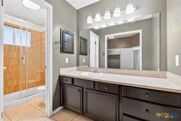 a bathroom with a sink double vanity and a mirror