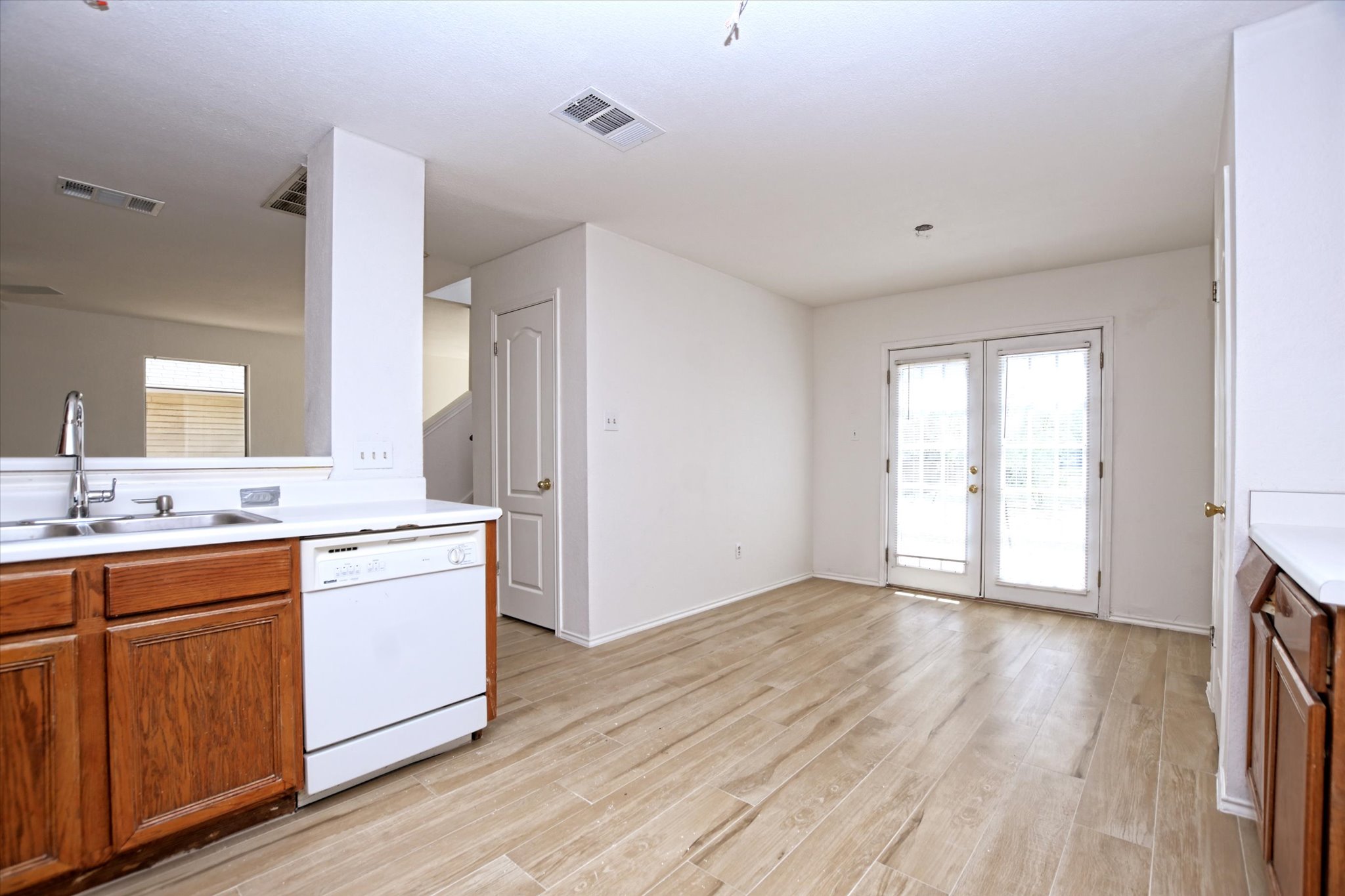 2509 Patsy Parkway Austin, TX 78744 - Photo 12 of 28 a view of a kitchen with a sink and dishwasher with wooden floor