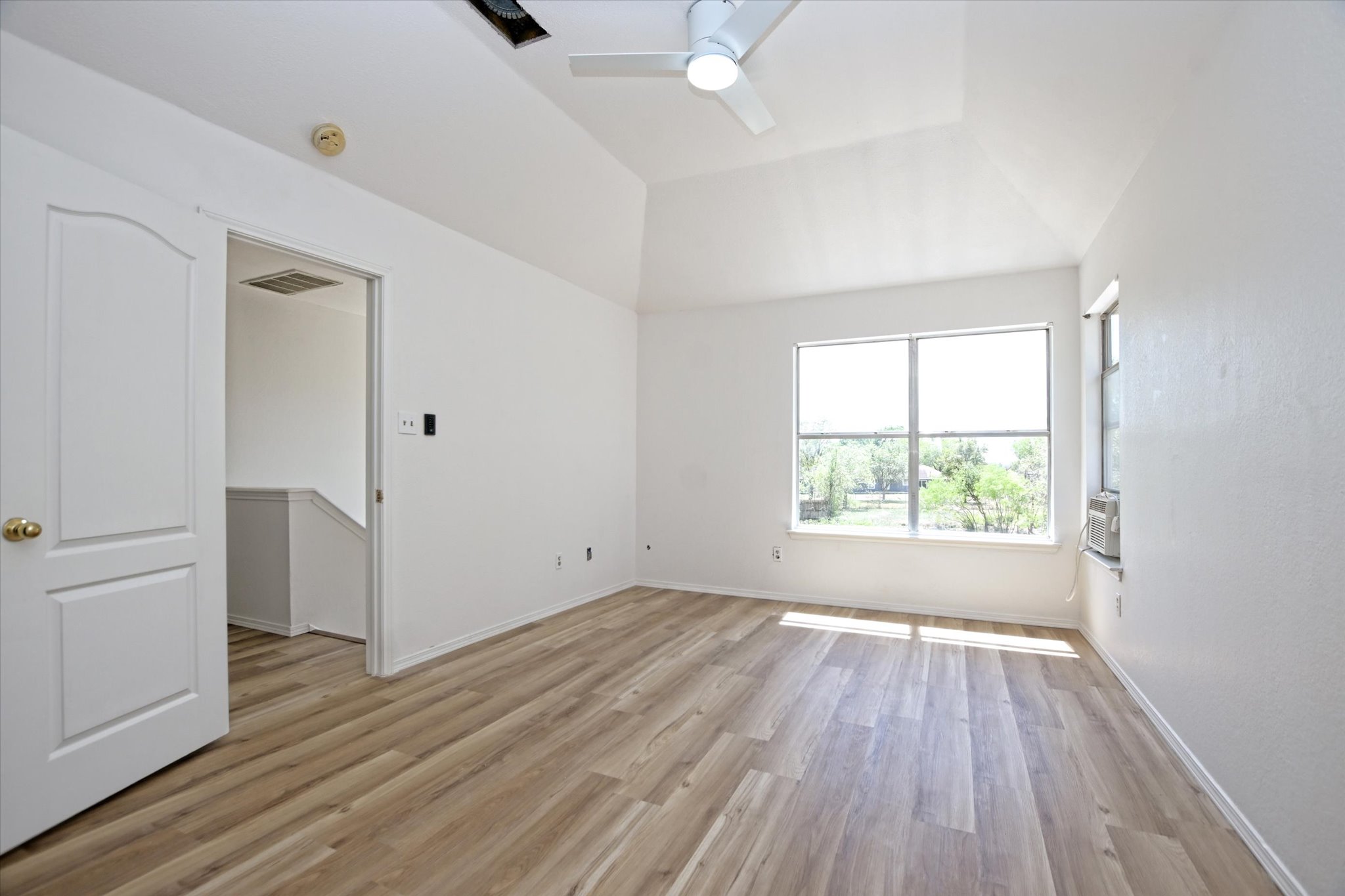 2509 Patsy Parkway Austin, TX 78744 - Photo 14 of 28 an empty room with wooden floor and windows