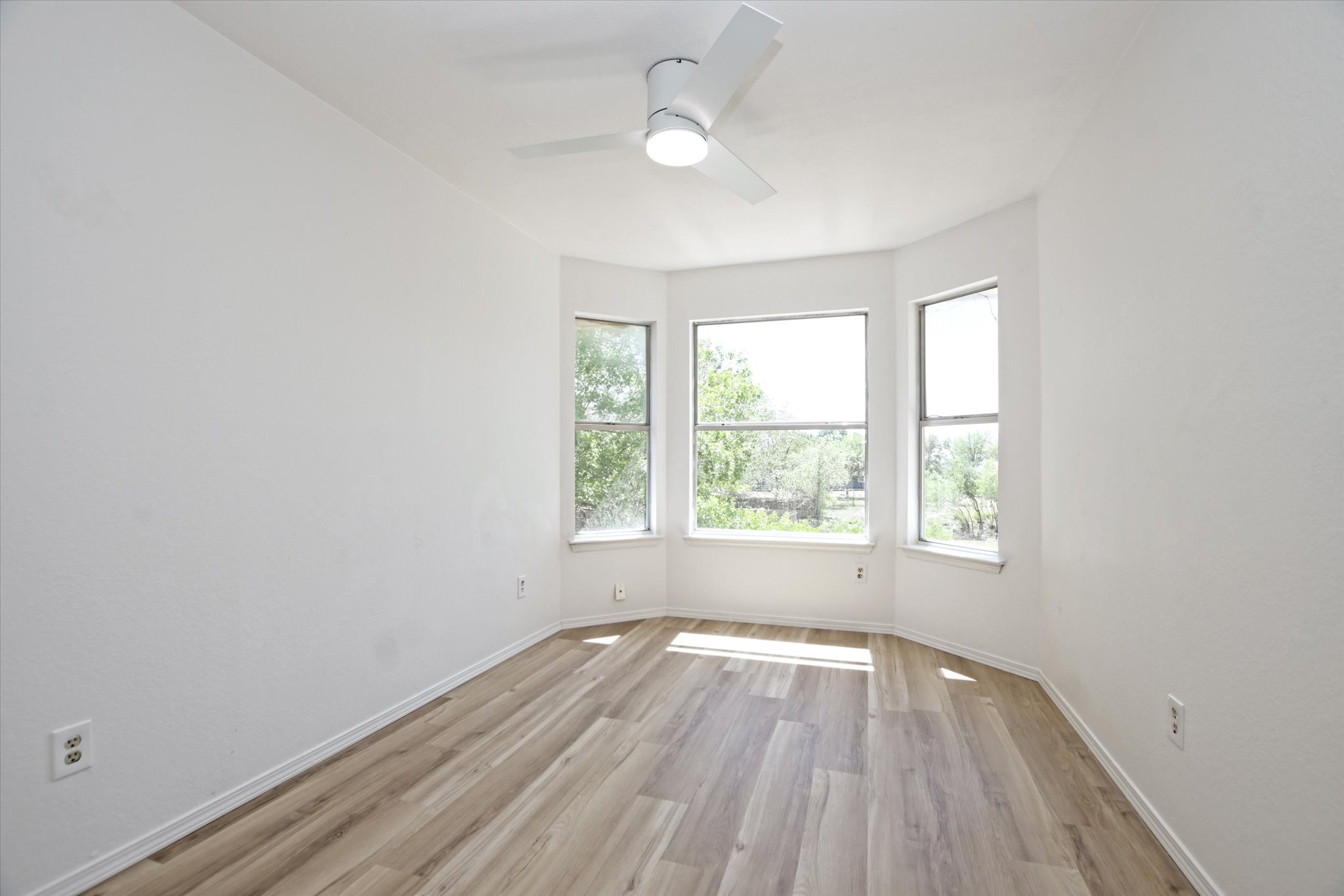 2509 Patsy Parkway Austin, TX 78744 - Photo 18 of 28 an empty room with wooden floor and windows