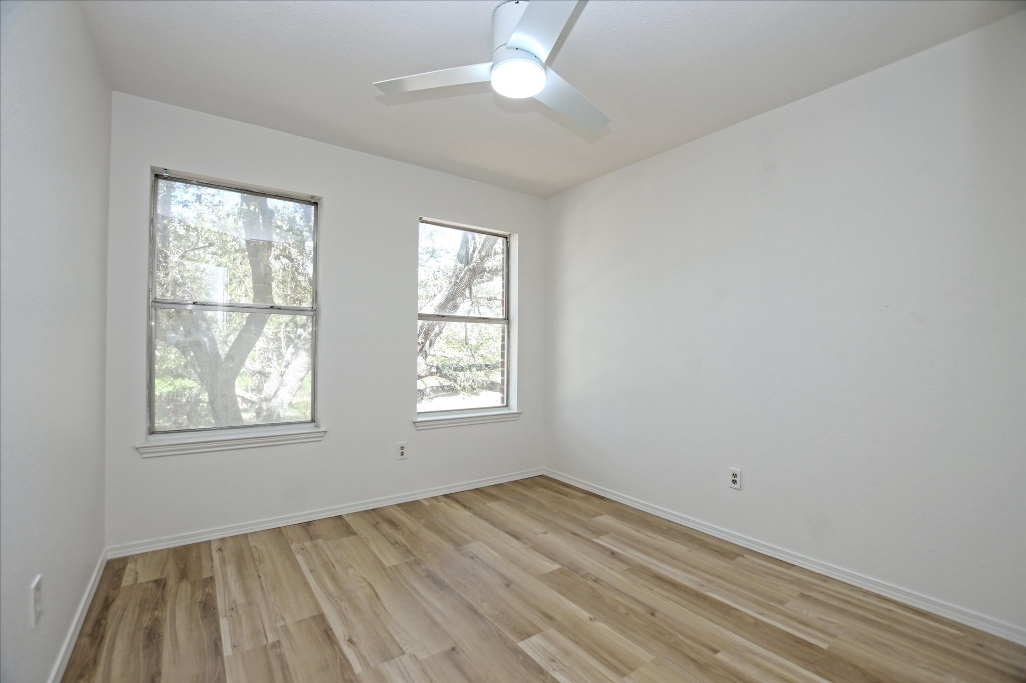 2509 Patsy Parkway Austin, TX 78744 - Photo 20 of 28 a view of empty room with wooden floor and fan