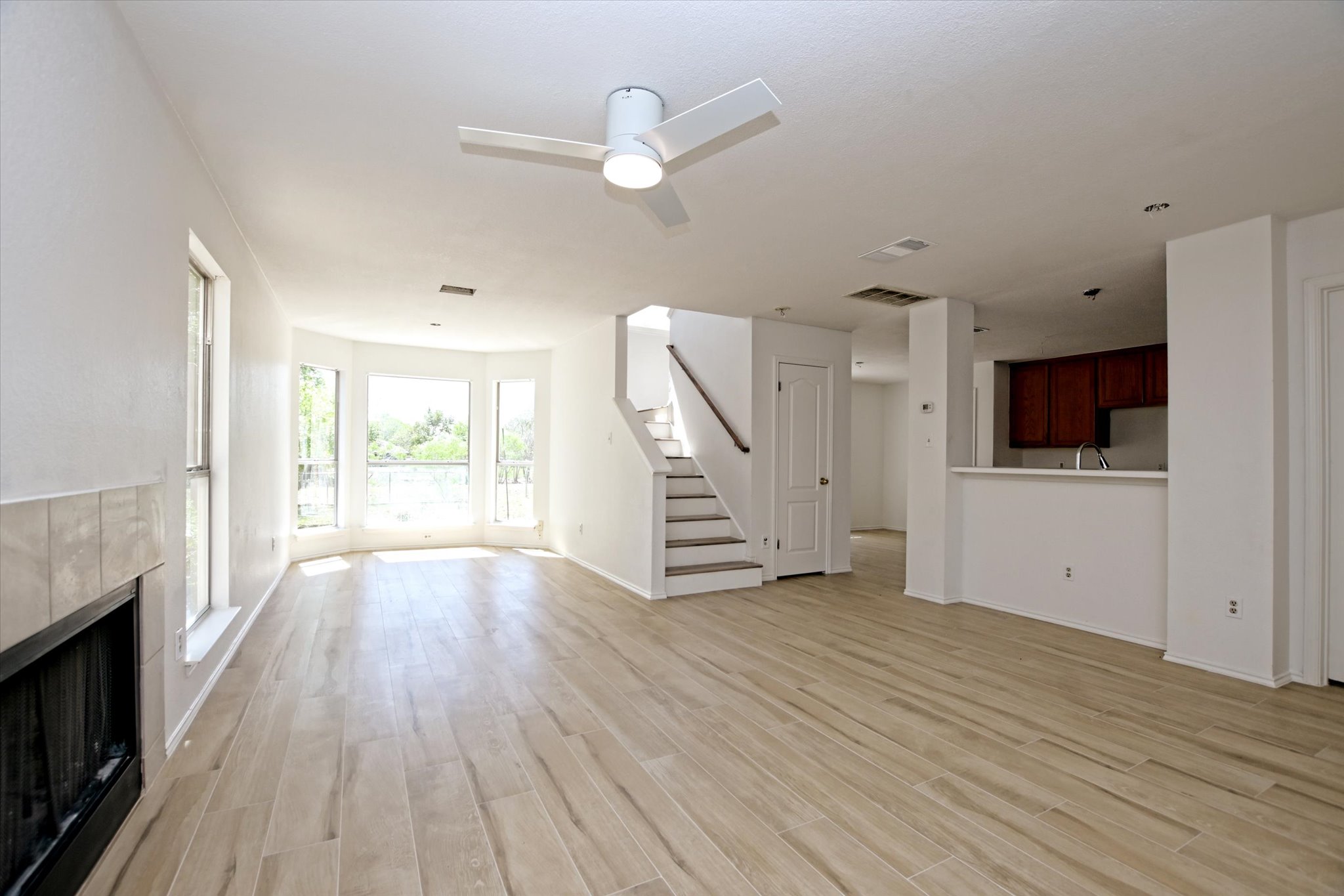 2509 Patsy Parkway Austin, TX 78744 - Photo 6 of 28 a view of an empty room with wooden floor and a window