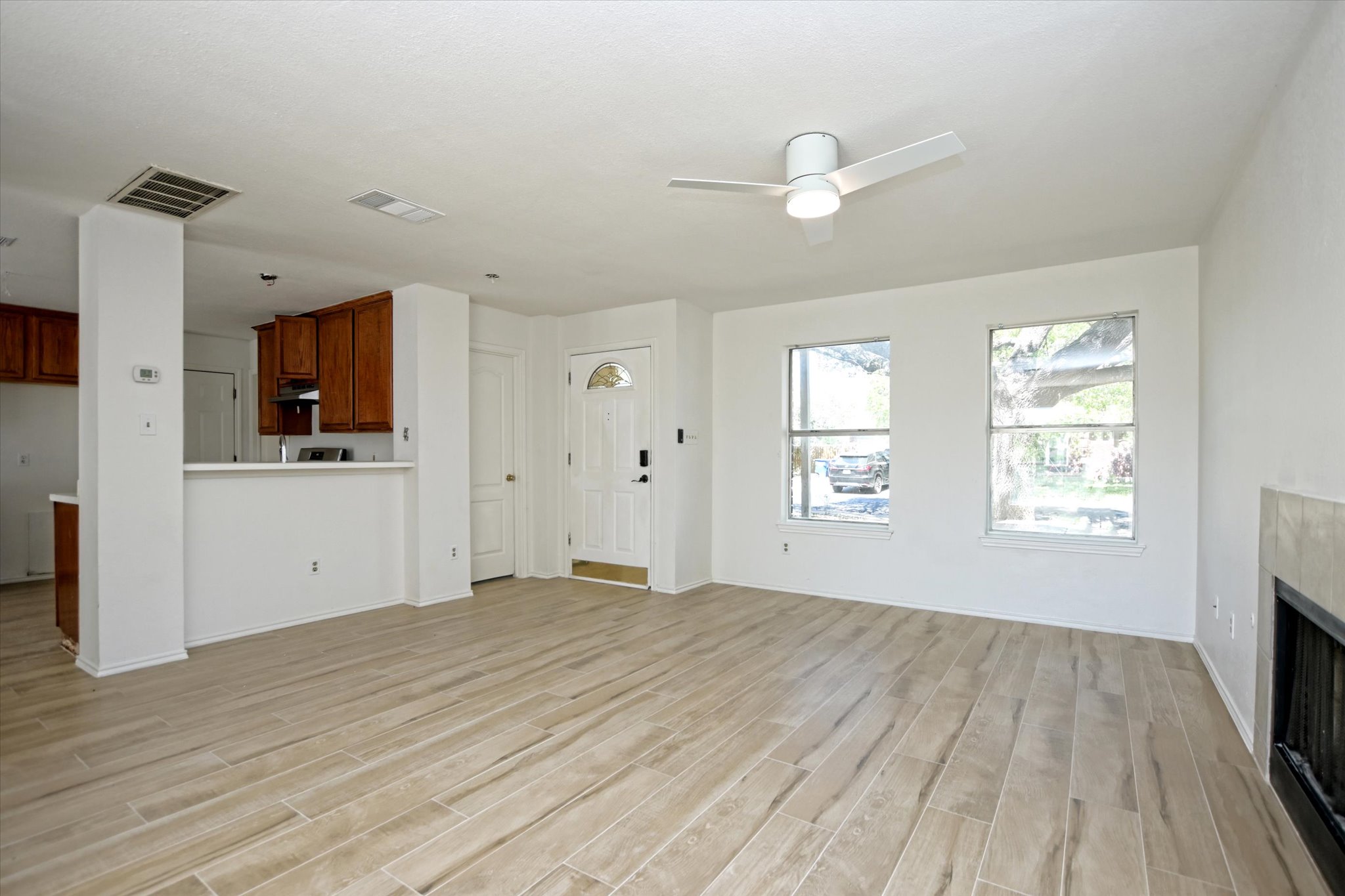2509 Patsy Parkway Austin, TX 78744 - Photo 7 of 28 a view of an empty room with a window and wooden floor