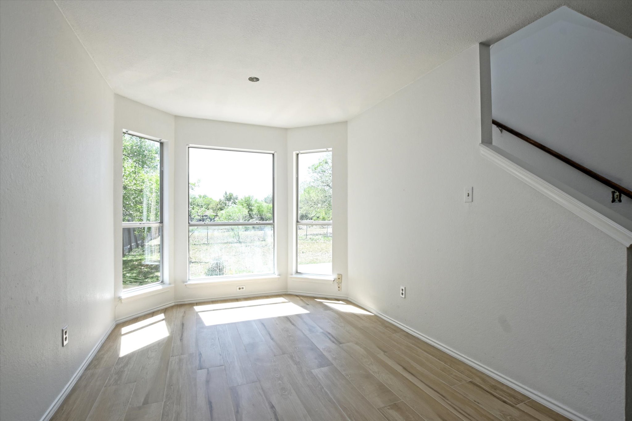 2509 Patsy Parkway Austin, TX 78744 - Photo 8 of 28 a view of an empty room with wooden floor and a window
