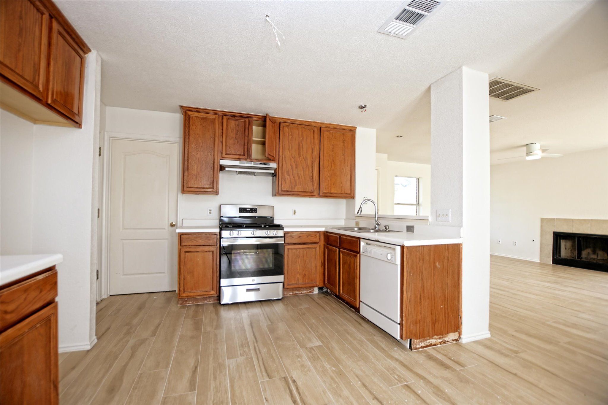 2509 Patsy Parkway Austin, TX 78744 - Photo 9 of 28 a kitchen with granite countertop a stove top oven sink and cabinets
